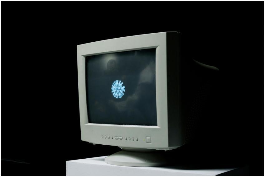 A vintage computer monitor shows an image of a cor