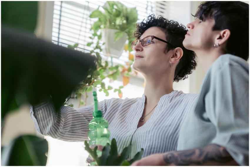Two women engaging in indoor gardening, nurturing