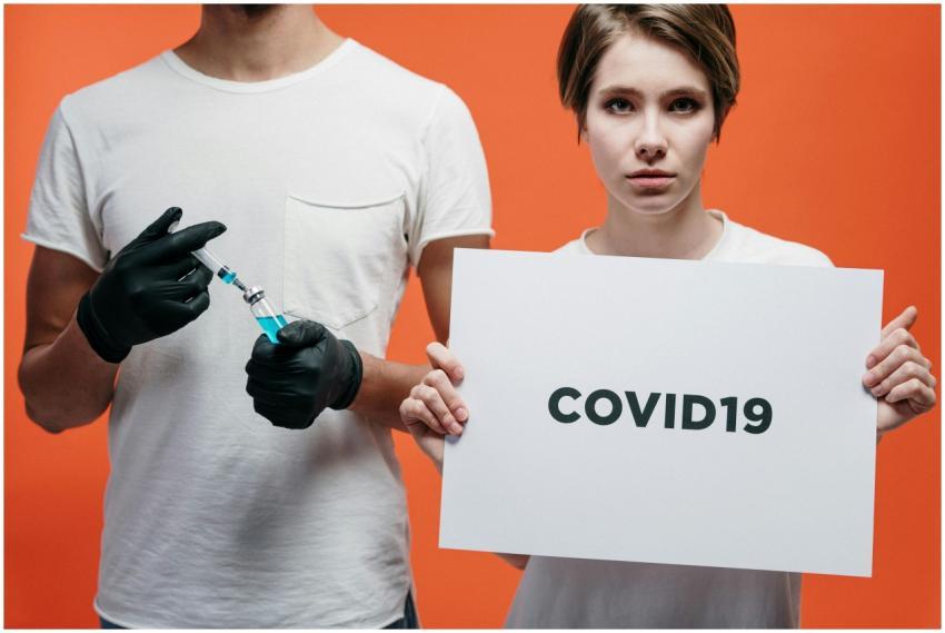 Two individuals highlighting COVID-19 vaccine and