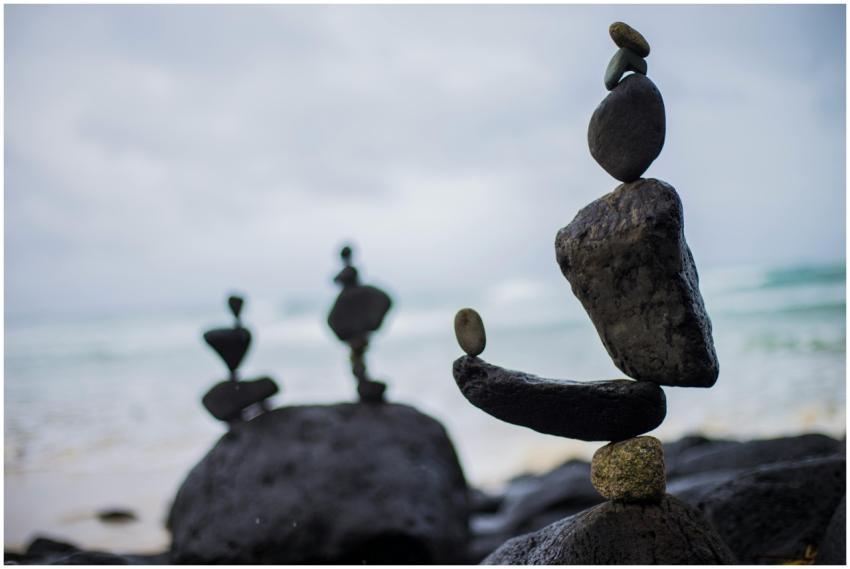 Artistic rock balancing on a serene beach in Finga