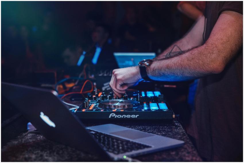 DJ performing with mixer in a vibrant nightclub se