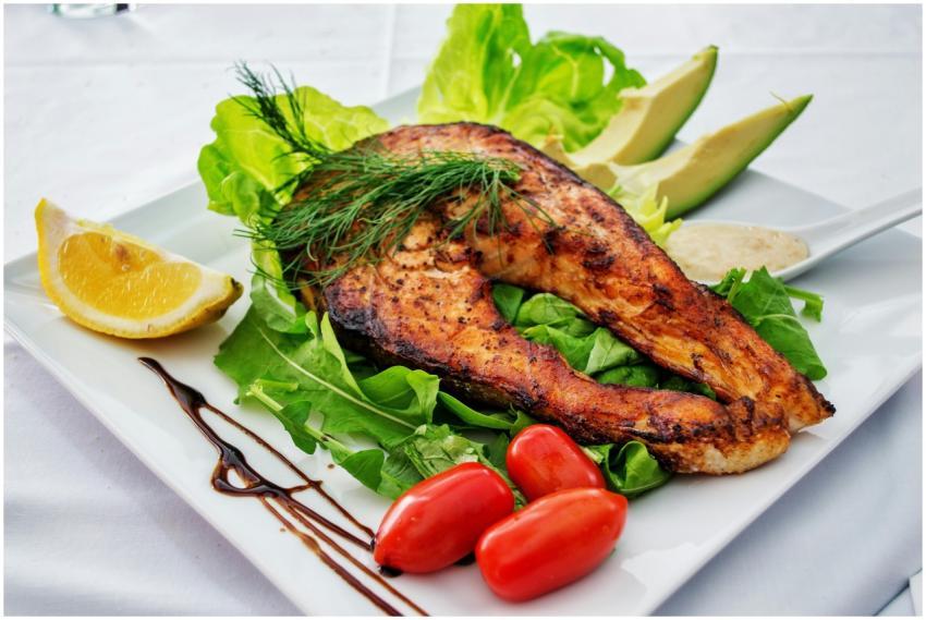 Delicious grilled salmon steak served with avocado