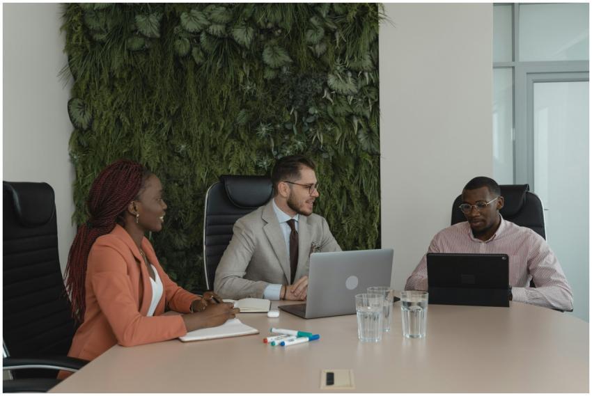 A diverse team collaborates in a modern office wit