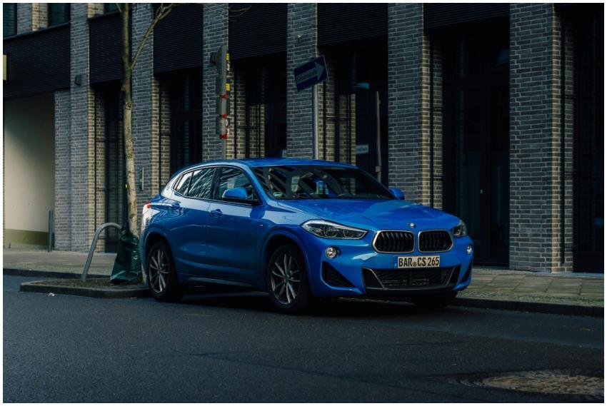 A striking blue SUV parked on a city street, showc
