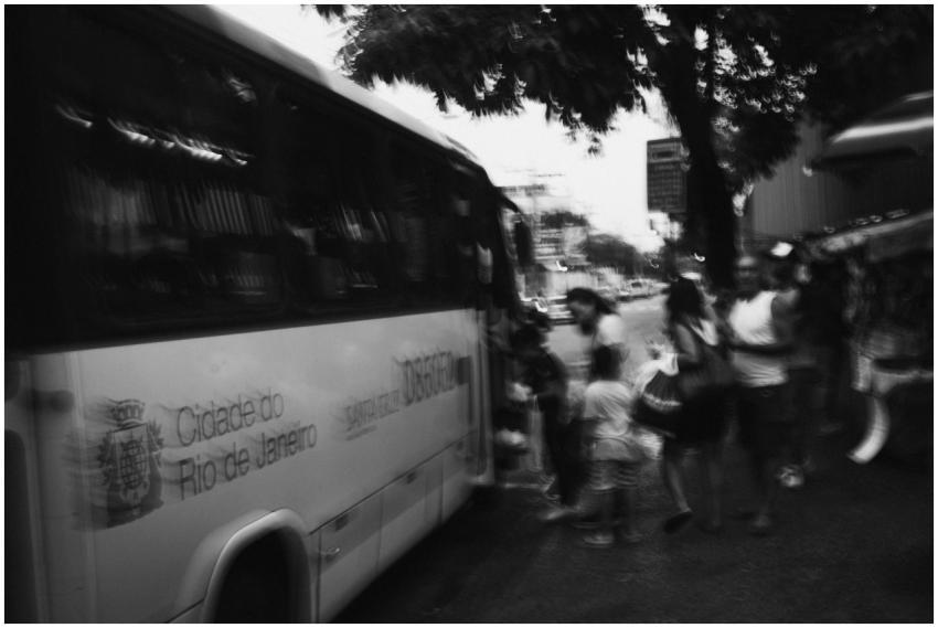 Blurred black and white photo of people boarding a