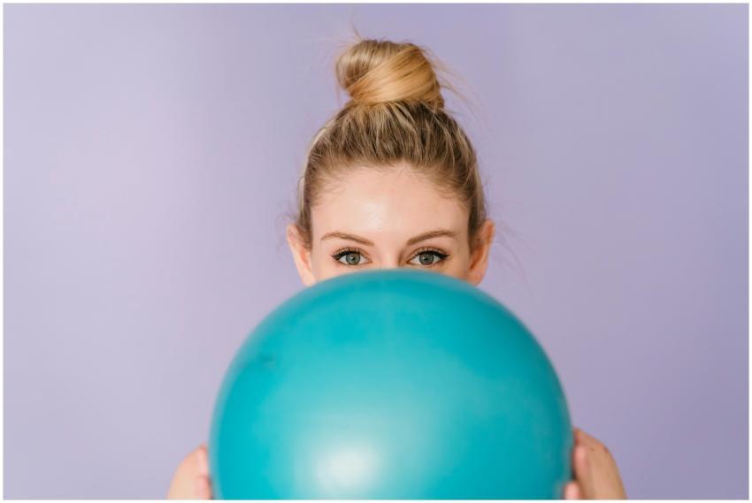 Cheerful anonymous female demonstrating blue shiny