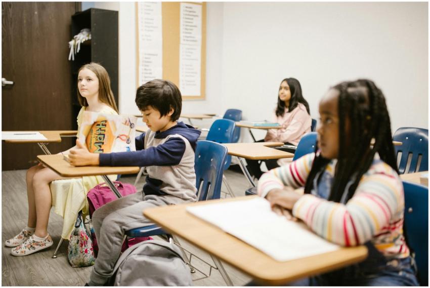 Children focused on a lesson in a diverse classroo