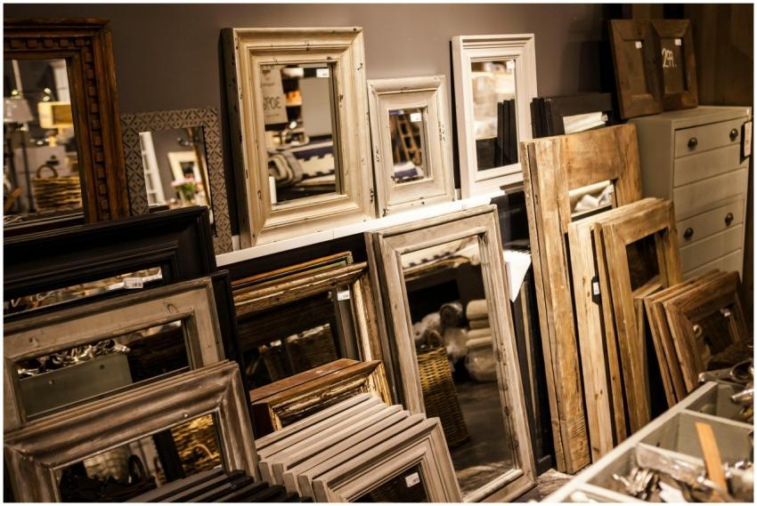 A collection of vintage-style mirror frames on dis
