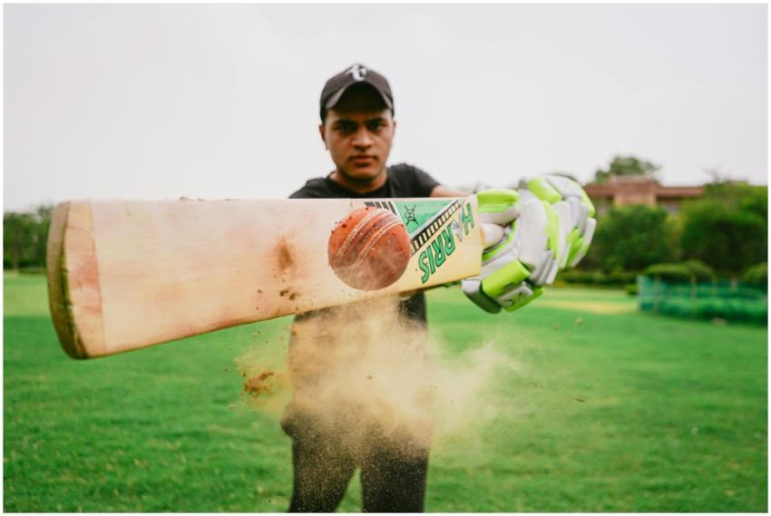 Closeup of cricket bat and ball hit by sportsman w