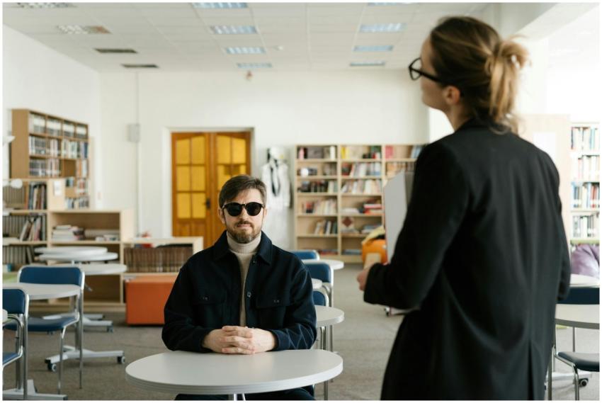Blind student engaged in classroom discussion with