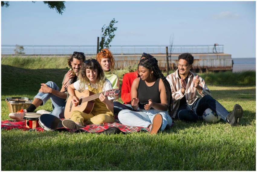 A group of friends enjoying a sunny outdoor picnic
