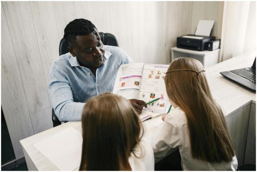 A teacher guiding students through a textbook duri
