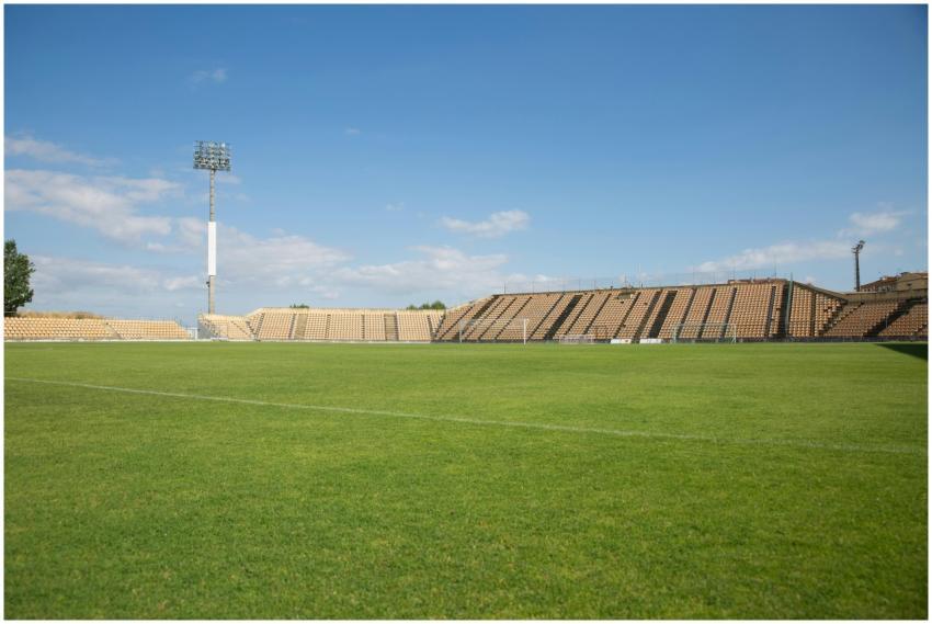 A bright, clear day at an empty football stadium i