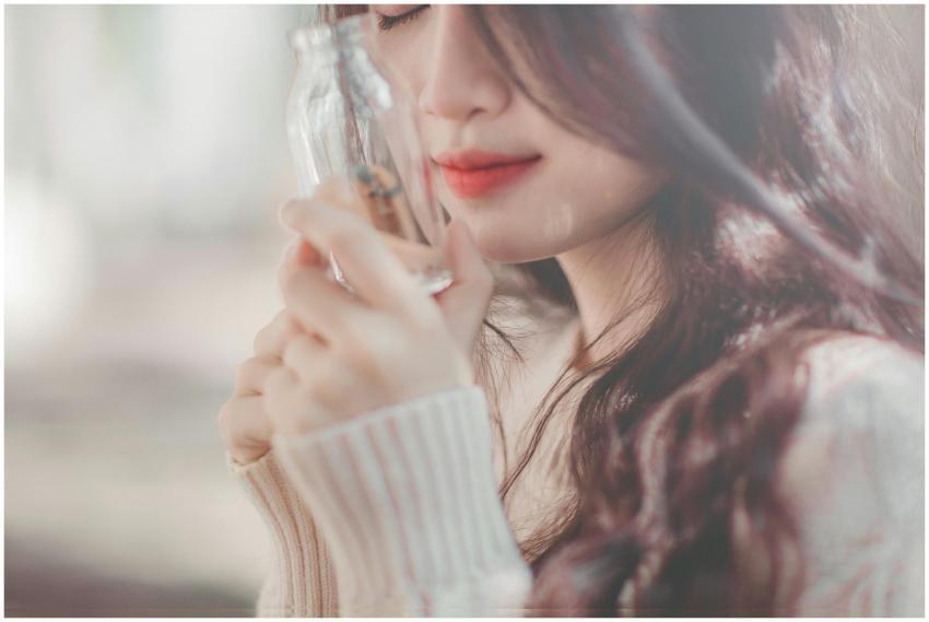 Close-up of a serene woman with long hair holding
