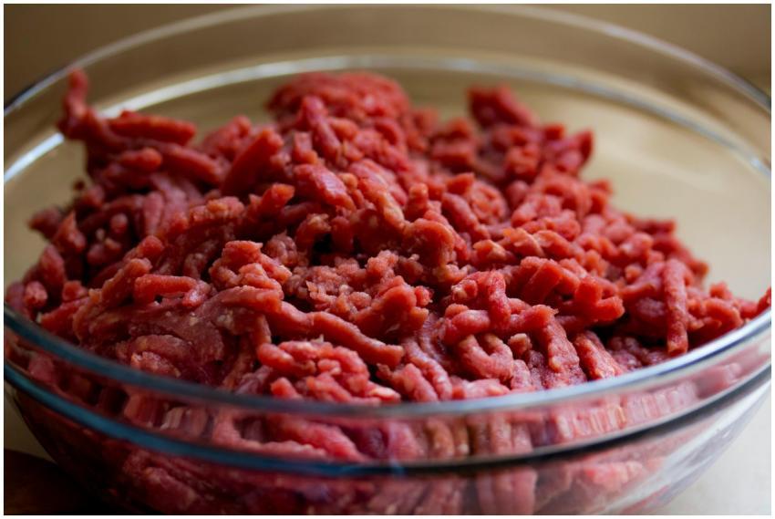High-quality image of fresh ground beef in a glass