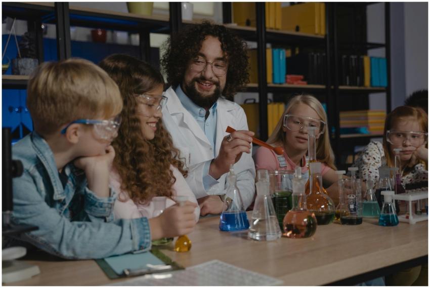 Students in a science class watch a chemistry expe