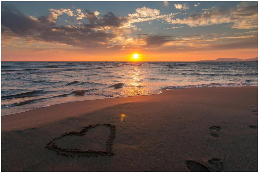 Beautiful sunset over ocean with a heart shape in