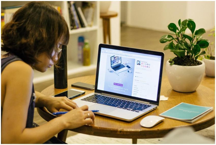 Woman working remotely from home with a laptop, pe