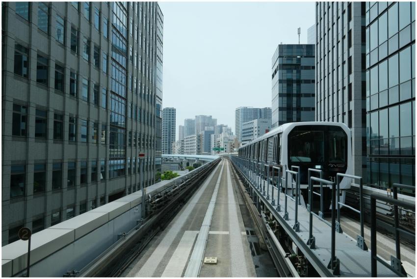 Monorail train moving through Tokyo's urban skylin