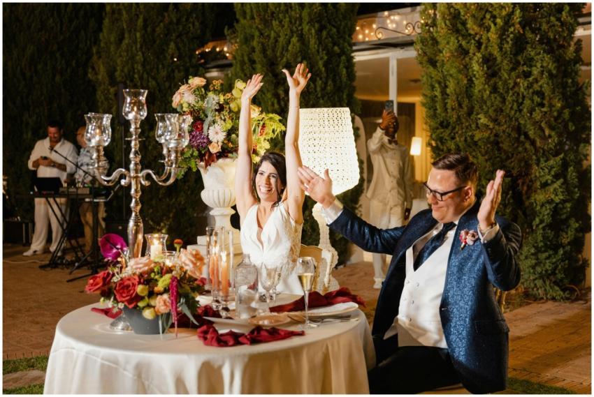 Joyful couple celebrating at an outdoor wedding re