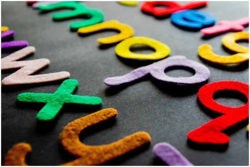 Colorful felt alphabet letters displayed on a dark