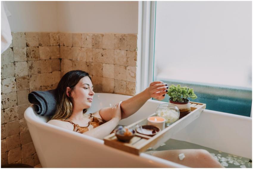 Woman enjoying a tranquil spa day with candles, fl