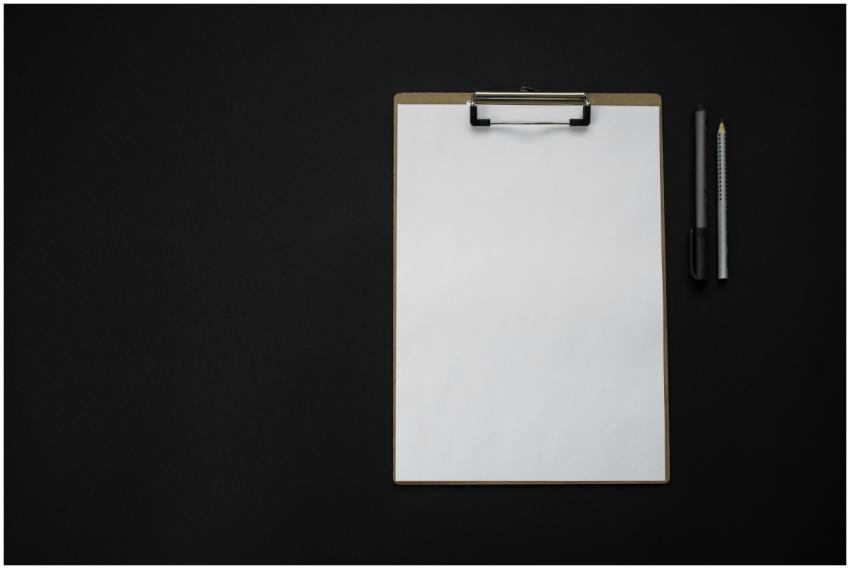 Flat lay of a blank clipboard with pen and pencil