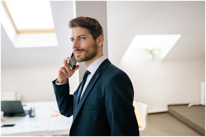 Professional businessman in a suit making a phone
