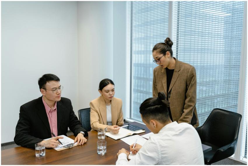 A group of business professionals engaged in a tea