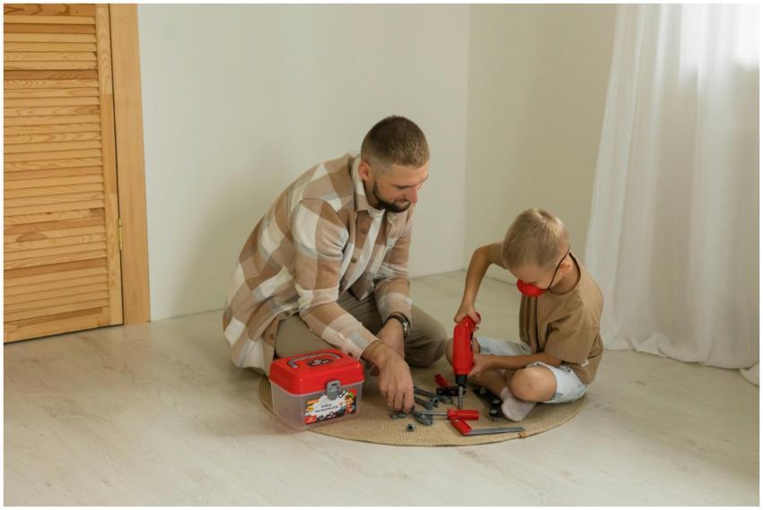A father and son bonding over a building project w