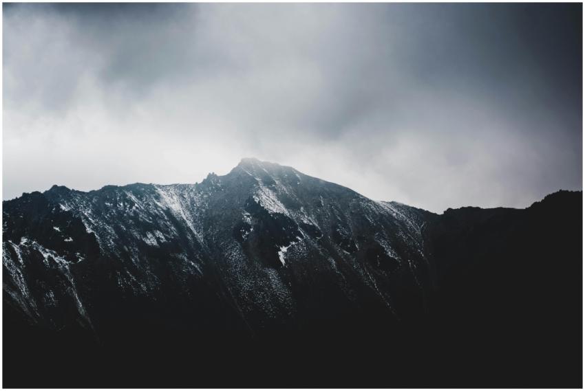 A stunning view of a snow-capped mountain peak wit