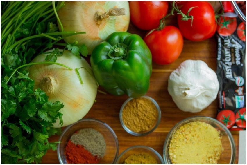 An assortment of fresh vegetables and spices on a