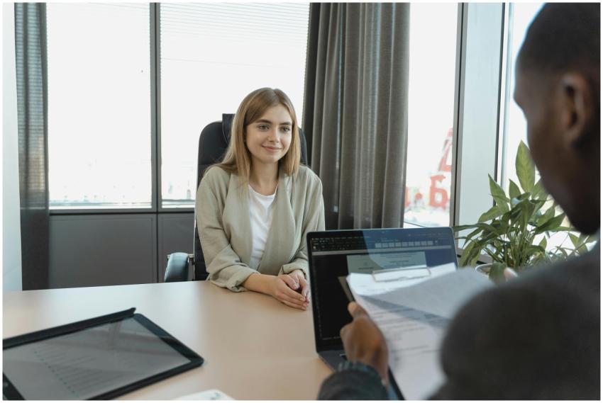 Young woman sitting confidently in a modern office