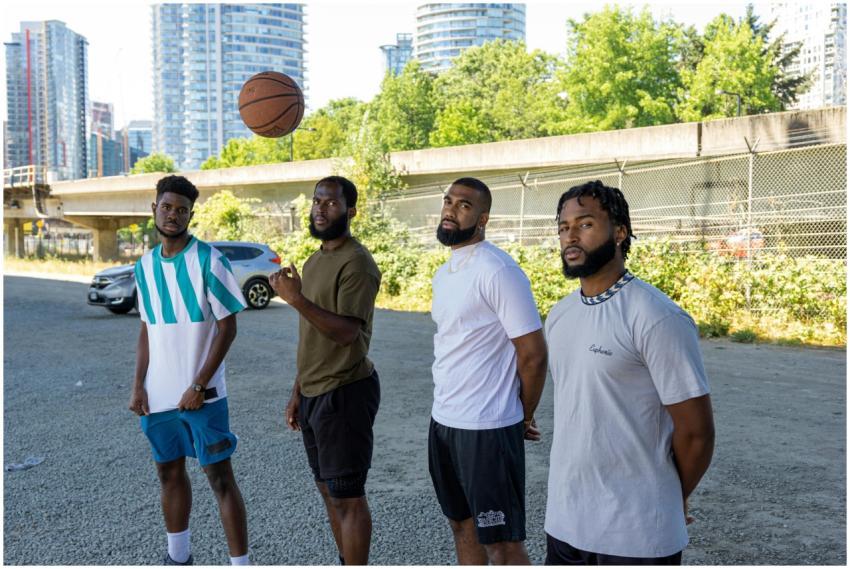 Four young men in sporty casual wear with a basket