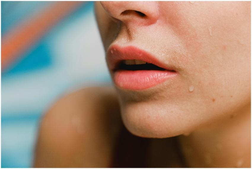 A close-up photo focusing on lips with water dropl