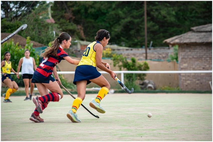 Dynamic shot of female field hockey players compet