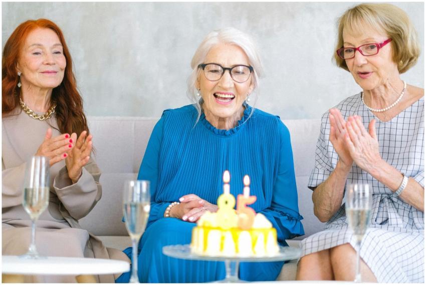 Positive elderly women in stylish clothes sitting