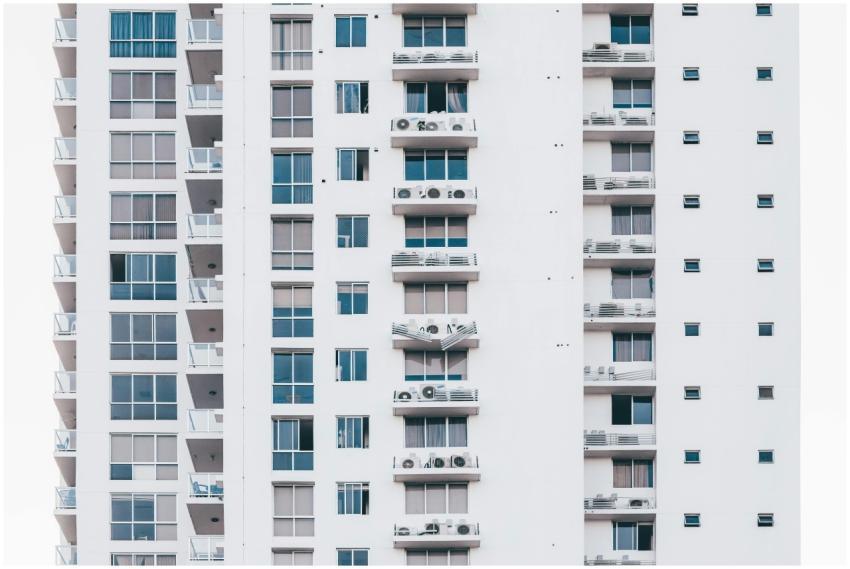 A sleek, modern high-rise building with a glass fa