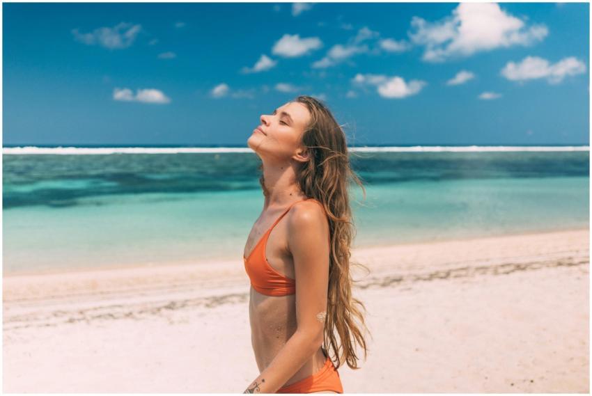 Woman in orange bikini relaxes and enjoys the sun