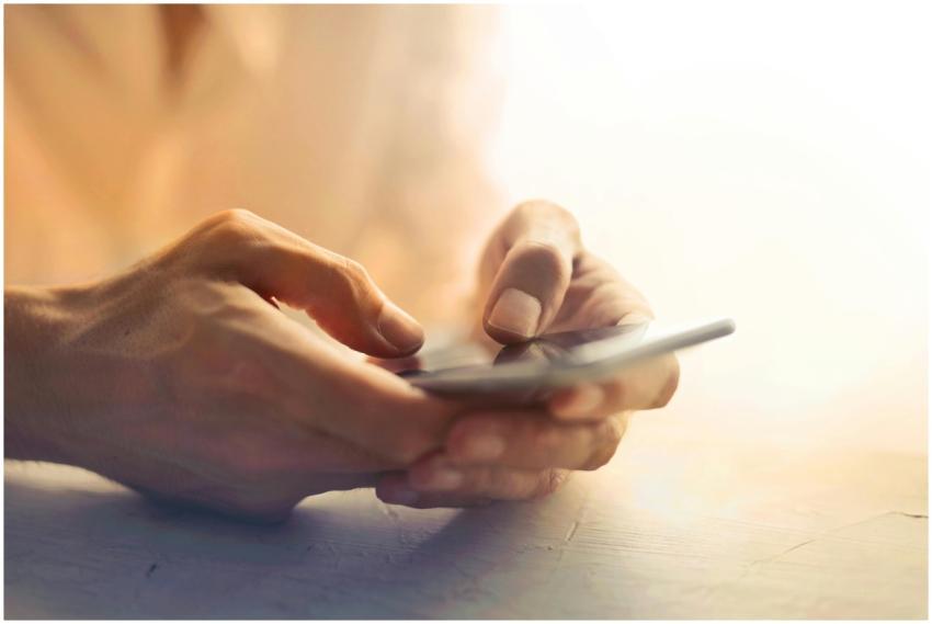 Detailed close-up of hands holding and using a sma