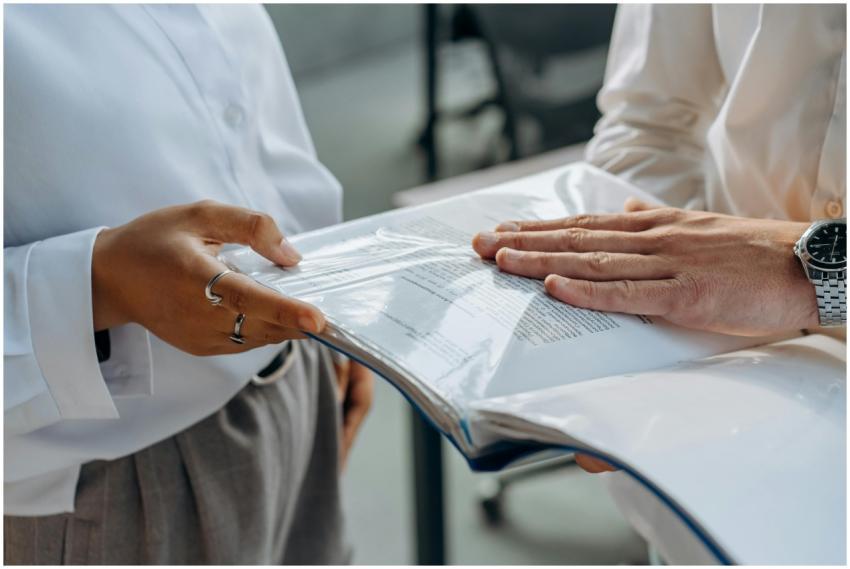 Two professionals examining business documents dur
