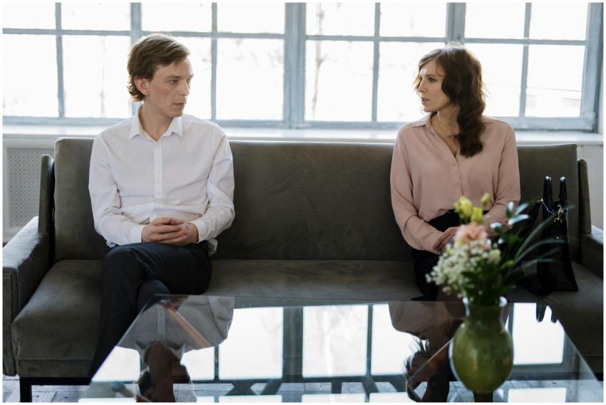 A couple engaged in a therapy session, seated on a