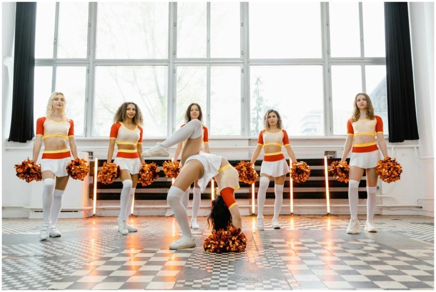 Cheerleaders performing inside, showcasing team sp