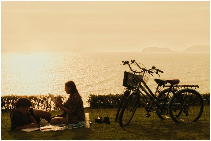 A couple enjoys a scenic picnic by the sea at suns