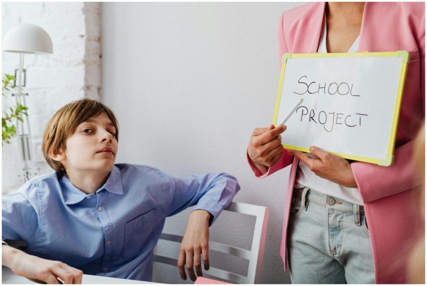 A teacher and student engage in a school project d