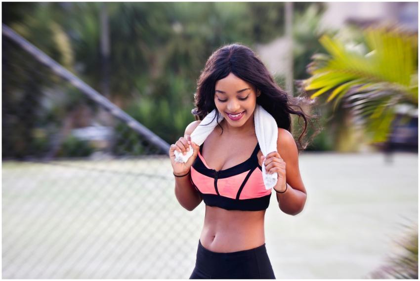 Smiling young woman in athletic wear enjoying her