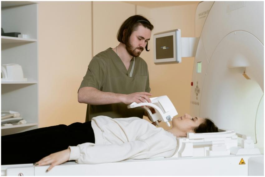 A healthcare worker prepares a patient for an MRI