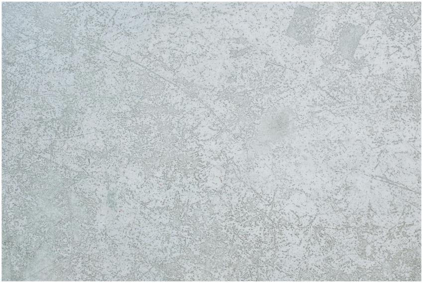 A detailed view of a textured grey concrete wall,
