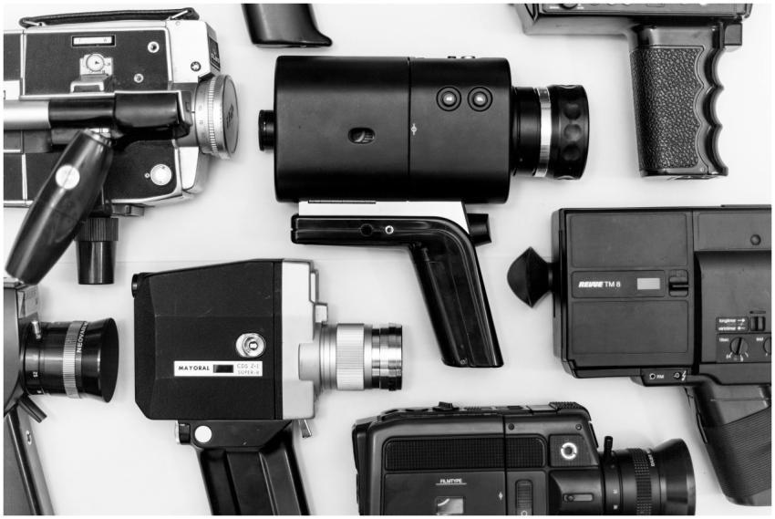 Flat lay of assorted vintage video cameras in blac