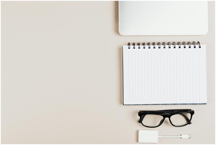 Top view of minimal office desk setup with notepad